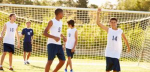 Group of adolescents playing soccer
