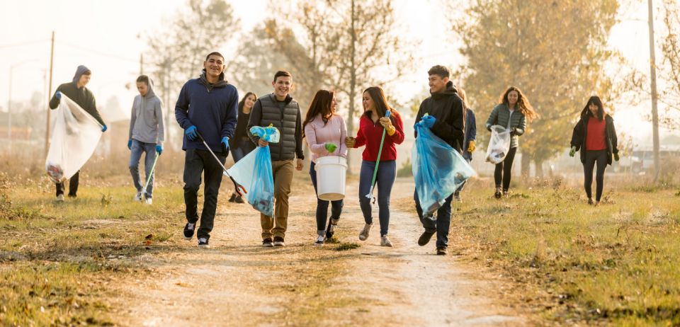 Group of adolescents picking up trash together